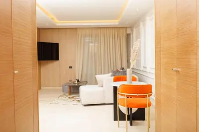 a living room with a white couch and a table at Luxury 2BR Apartment in Agdal for a Relaxing Stay in Es Souissi