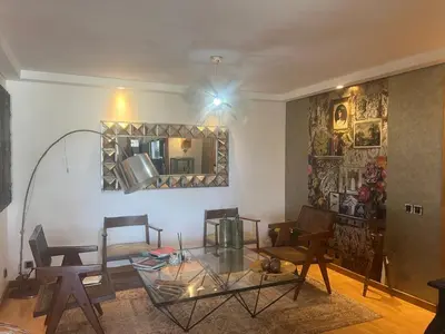 a living room with a glass table and chairs at Eden in Dar Bouazza