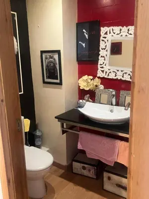 a bathroom with a sink and a toilet and a mirror at Eden in Dar Bouazza