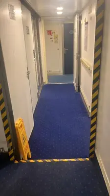 a hallway with blue flooring in an airplane at Amlas Bourgogne in Casablanca