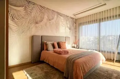 a bedroom with a large bed and a large window at Poolside Paradise Villa in Dar Ben Abdallah Ben Dehbi