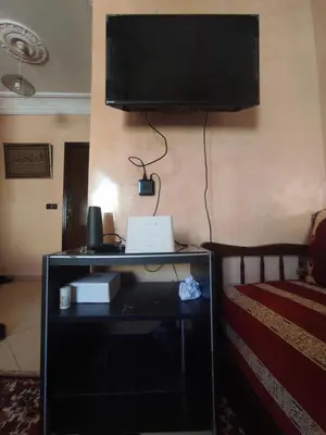 a bedroom with a bed and a television on a wall at Appartement familial calme 3 min à Casanearshore in Casablanca