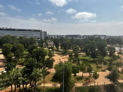 a park with trees and buildings in the background at Apartment à 1 min de Casanearshore in Casablanca