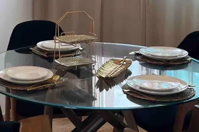 a glass table with plates on top of it at Magnifique 2 chambres avec rooftop - Casablanca Centre in Casablanca