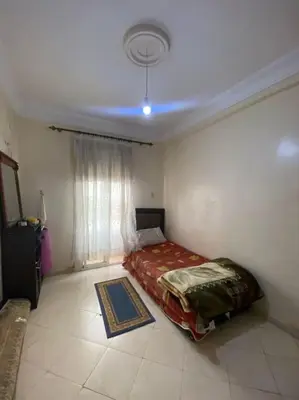 a bedroom with a bed in a room at Appartement Neo in Oulad Hamida
