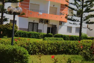 a building with a street light in front of a yard at Mohammedia 2 in Mohammedia