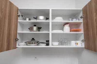 a kitchen cabinet filled with pots and pans at Zenitude in Casablanca