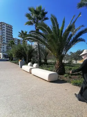 a person walking past a row of white objects at Zenitude in Casablanca