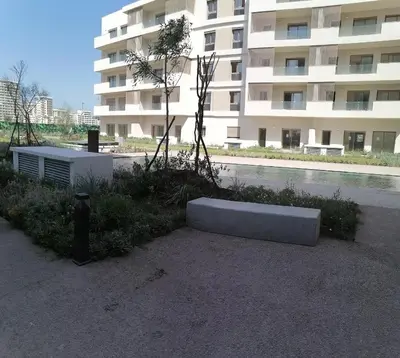 a concrete bench sitting in front of a building at Zenitude in Casablanca