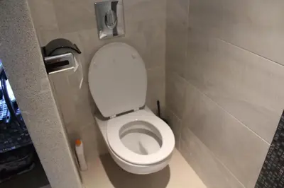 a bathroom with a white toilet in a stall at Paradise 7 in Pont Blondin
