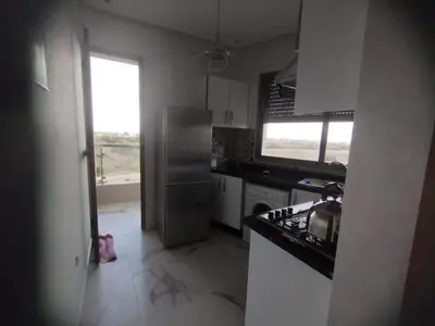 a kitchen with a stainless steel refrigerator and a window at appartement jinane in Bouznika