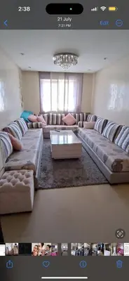 a large living room with couches and a table at الشقة دار بوعزة in Dar Bouazza
