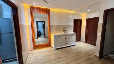 a bathroom with a dresser and a mirror at T1 App moderne 2 chambres, a 10 min du Stade Moulay Abdellah in Temara