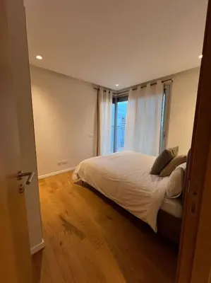 a bedroom with a bed and a large window at Beautiful Casablanca finance city Apartment in Casablanca