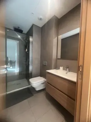 a bathroom with a toilet and a sink and a shower at Beautiful Casablanca finance city Apartment in Casablanca