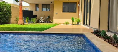 a swimming pool in front of a house at Villa Elia in Tamaris