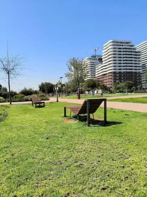 two benches in a park with buildings in the background at luxury Studio with jacuzzi in Casablanca