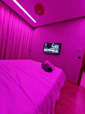 a pink bedroom with a bed and a tv at luxury Studio with jacuzzi in Casablanca