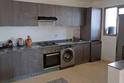 a kitchen with a washing machine and a dishwasher at newly and fully furnished appartment in sidi rahal in Sidi Rahal