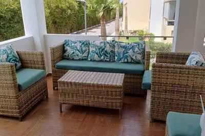 a porch with wicker chairs and a couch at newly and fully furnished appartment in sidi rahal in Sidi Rahal