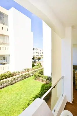 a view from the balcony of a building with a green lawn at newly and fully furnished appartment in sidi rahal in Sidi Rahal