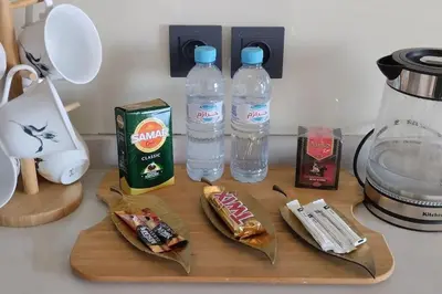 a cutting board with two bottles of water and food at Spacious Beachfront apartment in Casablanca