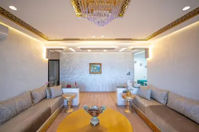 a living room with a couch and a table at Spacious Beachfront apartment in Casablanca