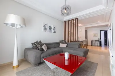 a living room with a couch and a red table at Appartement Moderne au Cœur de Rabat by MERAT HOME in Océan
