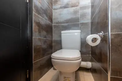 a bathroom with a toilet and a roll of toilet paper at Appartement Moderne au Cœur de Rabat by MERAT HOME in Océan