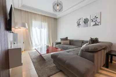 a living room with a couch and a table at Appartement Moderne au Cœur de Rabat by MERAT HOME in Océan