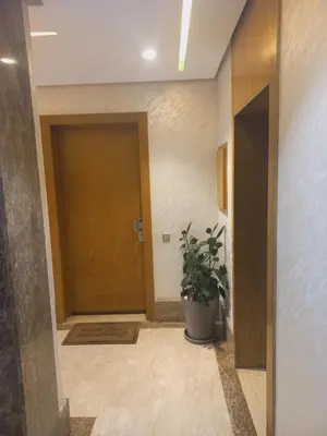 a hallway with a door and a potted plant at Résidence la vallée de Californie ahfad in Le Polo