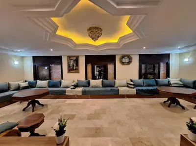 a large living room with a large couch and tables at Superbe Villa Avec Piscine & Belle Vue Sur Mer in Tamaris