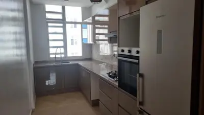 a large kitchen with a stove and a refrigerator at Très bel Appartement avec Piscine et Jardin in Mansouria