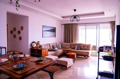 a living room with a couch and a table at Beautiful and Stylish 2BR Appartment with a wide Beach View in Mohammedia