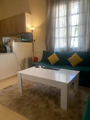 a living room with a couch and a white coffee table at Magnifique Studio Gare - Tram in Les Camps