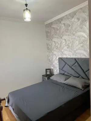 a bedroom with a large bed with a wall at Appartement Oasis beach in Pont Blondin