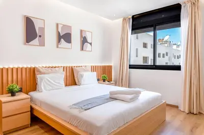 a bedroom with a large bed and a large window at Modern and Luxurious apartment in Rabat