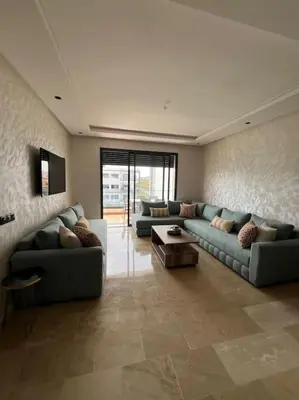 a large living room with two couches and a table at Studio Cosy avec Vue Piscine El Mansouria in Mansouria