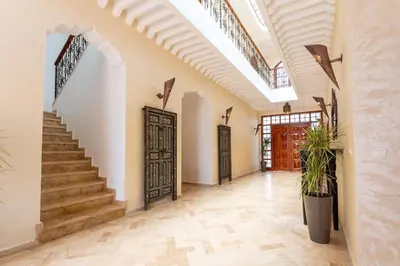 an empty hallway with stairs and a door in a house at Bienvenue au Château Loriana ! in Bouznika