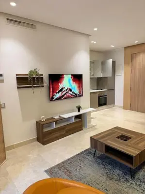 a living room with a tv on the wall at Little paradis Casablanca in Casablanca