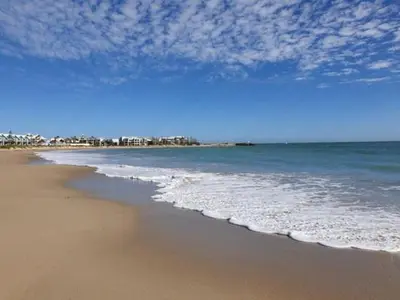 a view of the beach with the ocean at Bel Appartement avec Piscine et Jardin, EL MANSOURIA in Mansouria