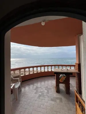 a view of the ocean from the balcony of a house at surf trip in Kasba Bou Hamira