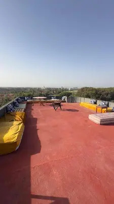 a patio with benches and tables on a roof at surf trip in Kasba Bou Hamira