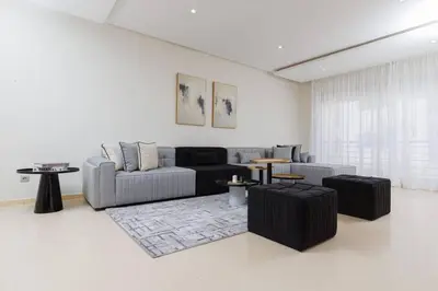 a living room with a couch and a table at Elegant 2BR in Hay Riad - New Furnishings & Design in Beni Brour