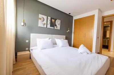 a bedroom with a large white bed with white pillows at Luxurious and modern 2BR with Stunning View in Beni Brour