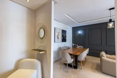 a dining room with a table and chairs at Luxurious and modern 2BR with Stunning View in Beni Brour