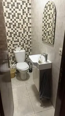a bathroom with a toilet and a sink and a mirror at Modern meets traditional ! in Casablanca