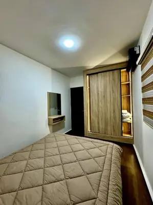 a bedroom with a large bed and a window at Jnane Jawhara Skhirat house in Skhirat