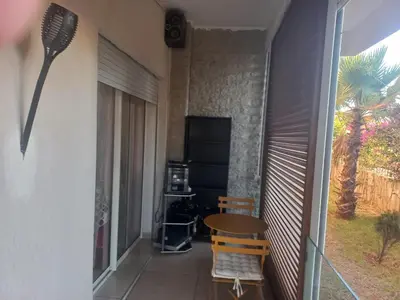a balcony with a table and chairs in a room at vague bleue de bouznika in Bouznika