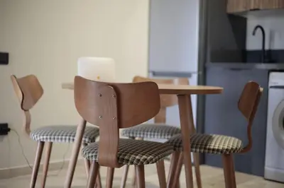 a wooden table and chairs in a kitchen at Studio cosy à Maârif, Palmiers in Maarif